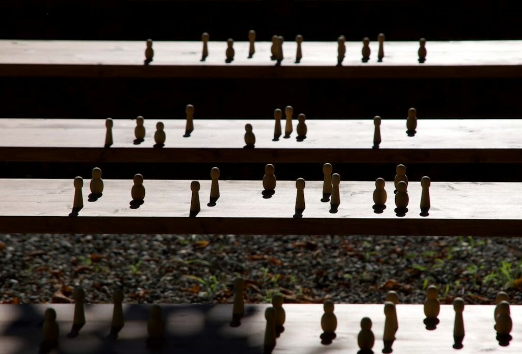  Set of wooden figurines on steps - concept of hierarchy 